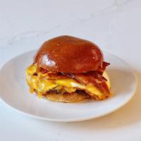 Hangover Helper · Bacon, fried egg, cheddar, caramelized onions and spicy aioli on brioche.