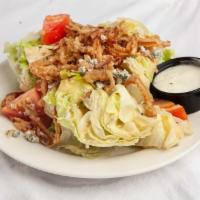 Wedge Salad · Iceburg lettuce, bacon, tomato, crumbled blue cheese and crispy onions with blue cheese dres...