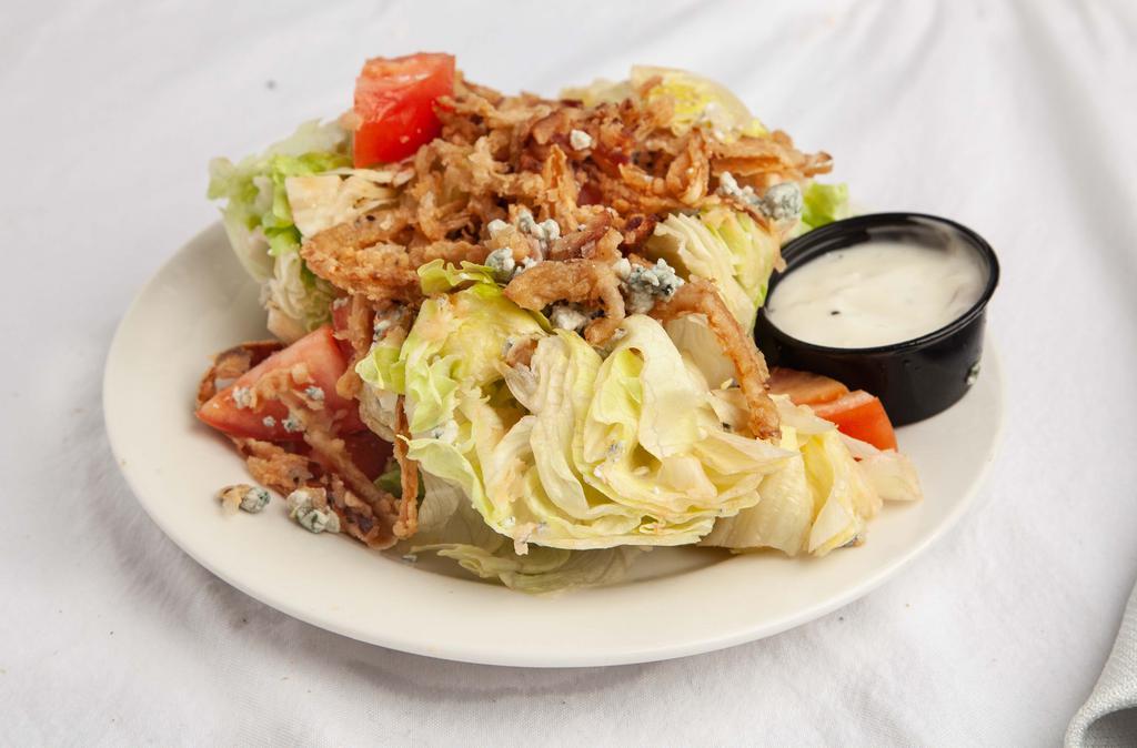 Wedge Salad · Iceburg lettuce, bacon, tomato, crumbled blue cheese and crispy onions with blue cheese dressing.