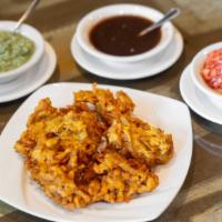 Onion Bhajia · Mildly spiced onion fritters.