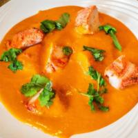 Chicken Tikka Masala · Marinated white meat chicken broiled in the clay oven then cooked in butter tomato creamy sa...