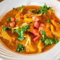 Chicken Curry · Tender pieces of chicken delicately cooked with herbs and spices in a mild gravy.