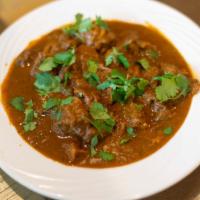Goat Curry · Fresh goat meat cooked in a mildly spicy gravy.