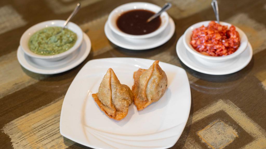Samosa Vegetable (2 Pcs) · Turnover filled with mildly spiced potato and peas.
