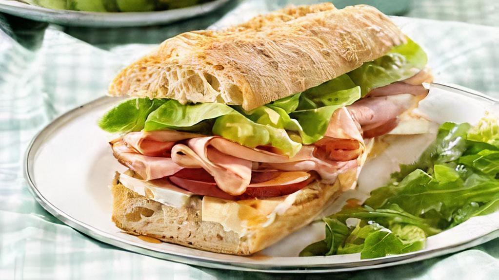 Jambon Fromage Baguette · French Heritage Delightful Smoked ham accompanied with Swiss cheese, lettuce, tomato, and Dijon mustard spread.