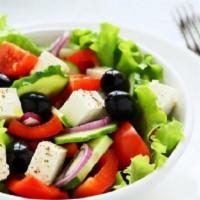 Greek Salad · Lettuce, onion, roma tomato, pitted black olives, feta cheese, Greek sauce.