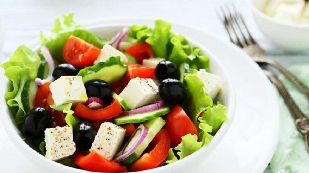 Greek Salad · Lettuce, onion, roma tomato, pitted black olives, feta cheese, Greek sauce.