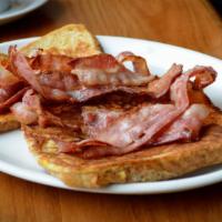 Bacon French Toast · Sliced challah bread soaked in eggs and milk, then fried and topped with crispy bacon served...