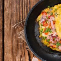 The Western Omelette · Fresh eggs, bell peppers, onions, and ham. Served with a side of home fries and hot toast.