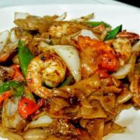 Drunken Noodle · Spicy. Stir-fried flat noodles with onions, bell peppers, tomatoes and basil in our spicy ch...