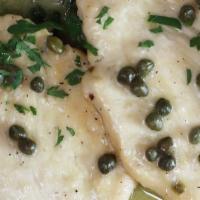 Veal Piccata · Sautéed in white wine and butter sauce with a whisper of lemon over spinach.