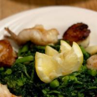 Seared Shrimp And Sea Scallops · Pan seared over broccoli rabe.