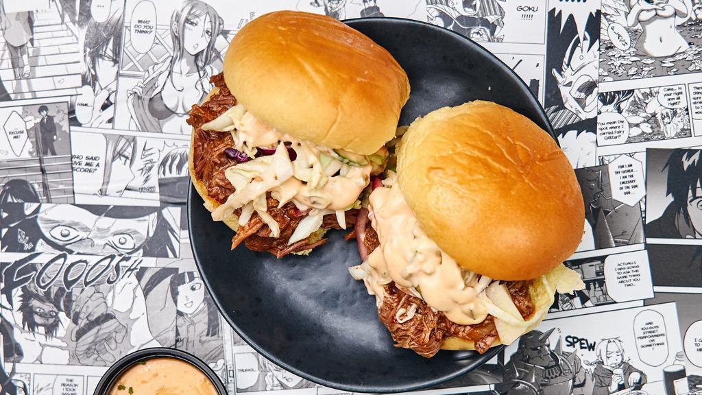 Two Bbq Beef Sliders · Slowly smoked hand-pulled BBQ beef doused in our homemade bbq sauce served in soft potato slders with cabbage slaw and our Crack sauce.