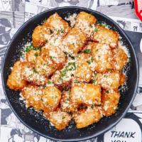 Truffle Parmesan Tots · Crispy tater tots with freshly grated parmesan cheese, white truffle oil and chives.