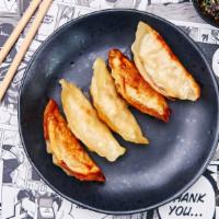 Homemade Yaki Pork Gyoza · Five pieces of homemade steamed pork dumplings.