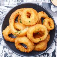 Onion Rings · Juicy white onions battered and fried to a crispy perfection served with our crack sauce.