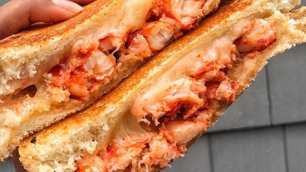 Jack'S Lobster Grilled Cheese · delicious Lobster meat, mixed cheese on a crispy Texas toast. goes great with lobster bisque soup sold seperatly . dip in it and bite it! yumm... served w/ homemade coleslaw, pickles and your choice of house salad or homemade potato chips.