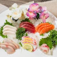 Sashimi Deluxe · 18 pieces of sashimi. Served with miso soup or salad.