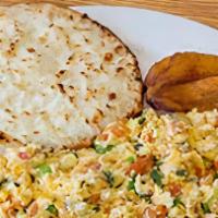 Huevos Pericos Y Arepa Con Queso · Scrambled eggs and corn cake with cheese.
