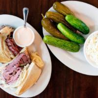 Reuben With Pastrami Sandwich · With sauerkraut and melted Swiss. Served on rye bread and pickles.