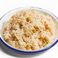 Coconut Rice And Peas · Long grain rice and sweet peas, simmered with coconut milk, thyme, and onion