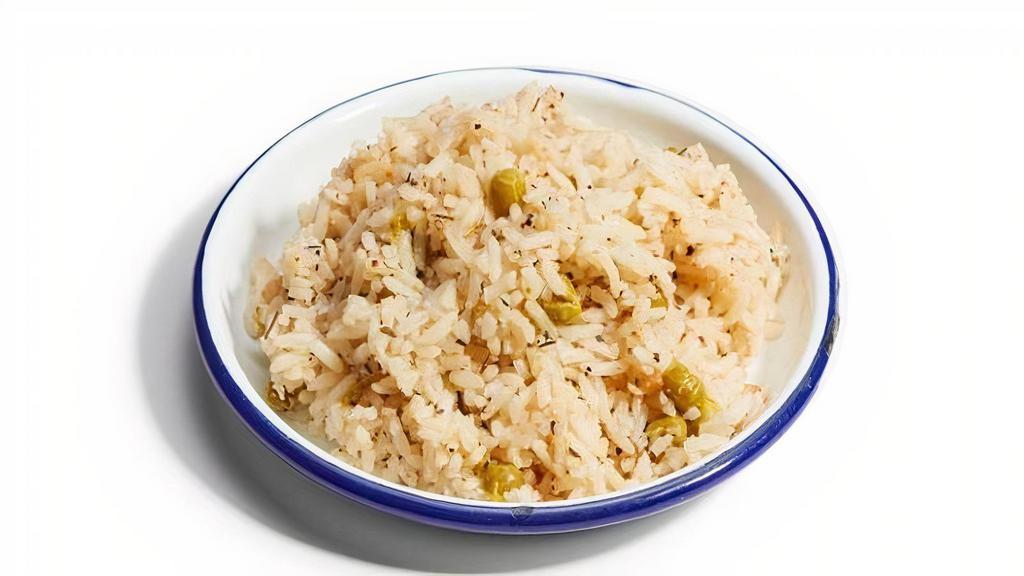 Coconut Rice And Peas · Long grain rice and sweet peas, simmered with coconut milk, thyme, and onion