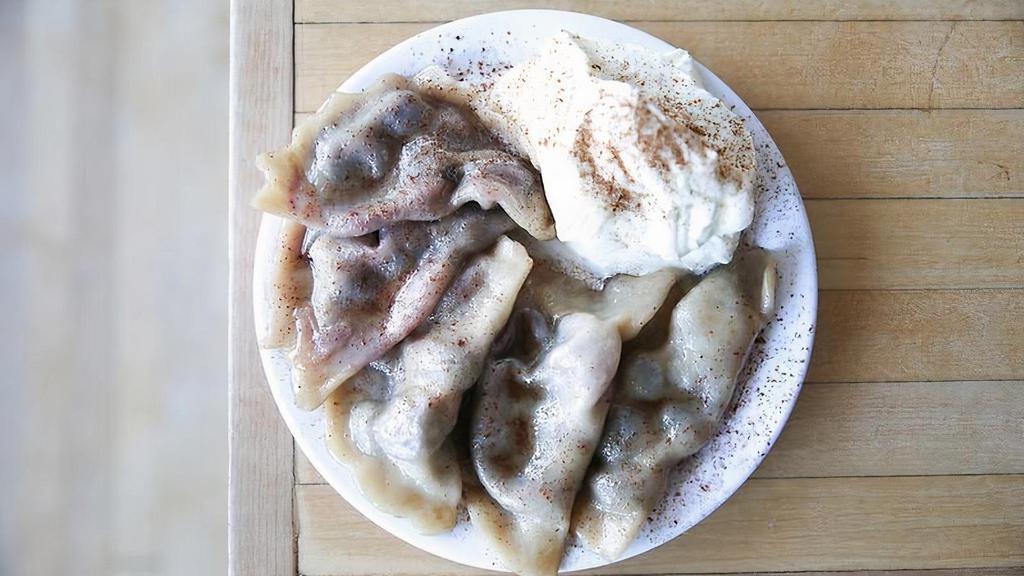 Blueberry(5) · 5 blueberry pierogies boiled and tossed in baba's sweet butter and cinnamon. Comes with whipped cream.
