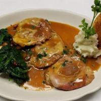 Saltimbocca · Veal scalloppini with prosciutto sage sauce served on a bed of spinach.