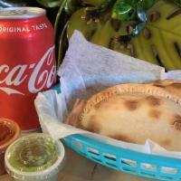 Combo 1 · Two Empanadas, two sauces & one can of soda.