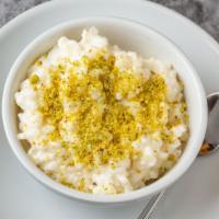 Shir Birinj · Homemade Afghan style rice pudding. Garnished with minced pistachios.