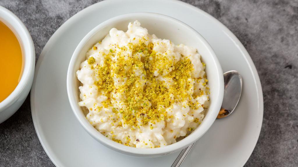 Shir Birinj · Homemade Afghan style rice pudding. Garnished with minced pistachios.