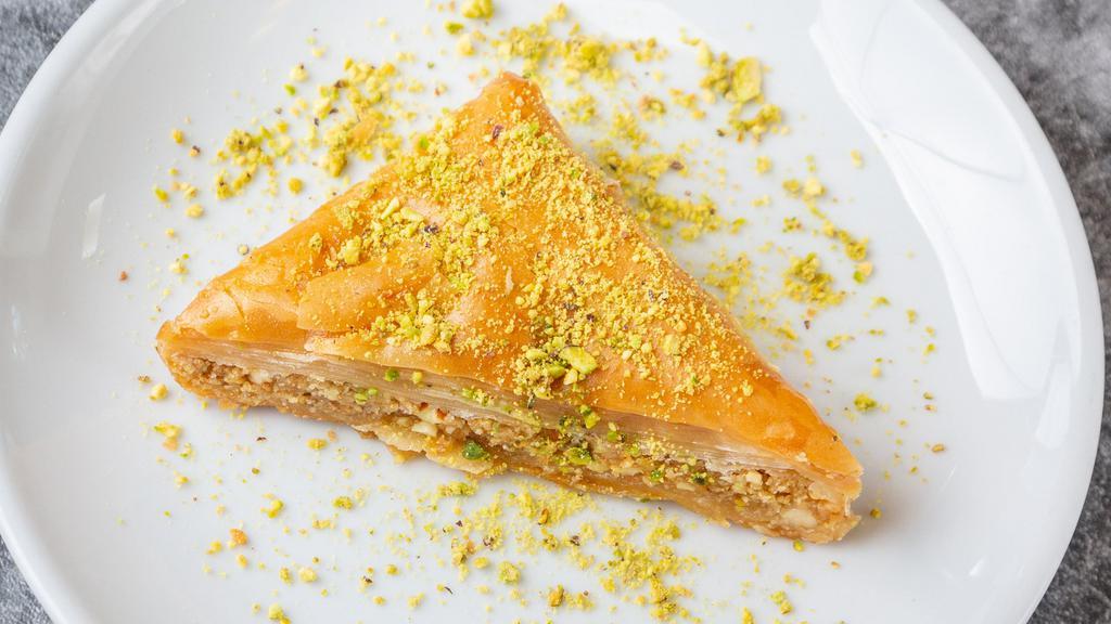 Baklava · Layers of buttery phyllo dough stuffed with chopped nuts and cinnamon. Soaked in a honey.