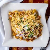 Samosa Chaat · Potatoes and green peas, triangular hand rolled pastry with sweet and sour emulsion of chaat.