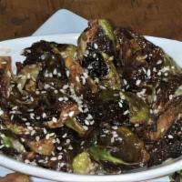 Fried Brussels Sprouts · Fried brussels sprouts with green apple sauce reduction top with sesames and drizzle a of oi...