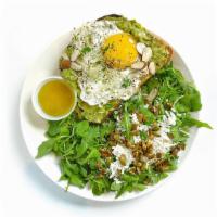 Avocado Toast With Egg · Avocado, feta cheese, parsley, and sliced almonds. Topped with sunny side up egg. Side salad...
