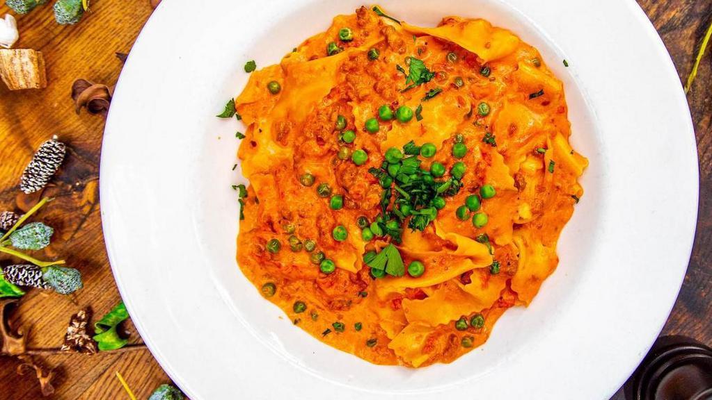 Pappardelle Alla Buttera   · Homemade pasta w/ crumbled hot Italian sausage, peas, tomato sauce, a touch of cream