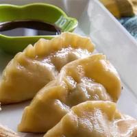 Pork Pot Sticker · Homemade pan-fried pork dumpling. Served with water chestnuts in ginger with soy dipping sau...