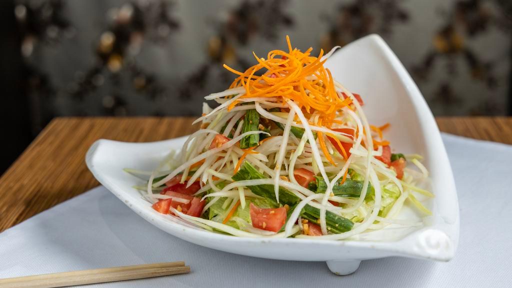 Som Tam Salad · Spicy.  Papaya salad. Thai stripped spice green papaya salad with string beans, tomatoes and crushed peanuts in a chili-lime vinaigrette. Spicy.