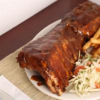 Bbq Ribs · Our slow cooked pork ribs basted in BBQ sauce served with cabbage salad and choice of French...