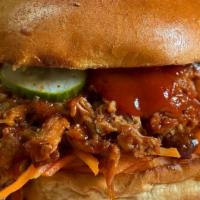 Pulled Pork Sandwich · Twelve  hour smoked pork shoulder, tossed in our bible belt BBQ sauce. Served with pickled c...