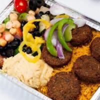 Falafel Over Rice · Served over brown basmati rice with choice of salad and Shah's sauces.