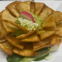 Nachos Con Guacamole · Tortilla chips with guacamole.