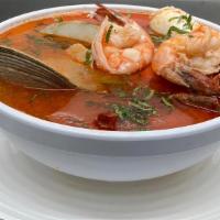 Sopa De Mariscos · Seafood soup (crab, clams, and shrimps) served with a side of rice, and a corn flour tortill...