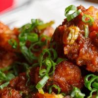 Gobi Manchurian · Fried cauliflower fritters tossed with soya sauce based gravy cooked to the chef's perfection.
