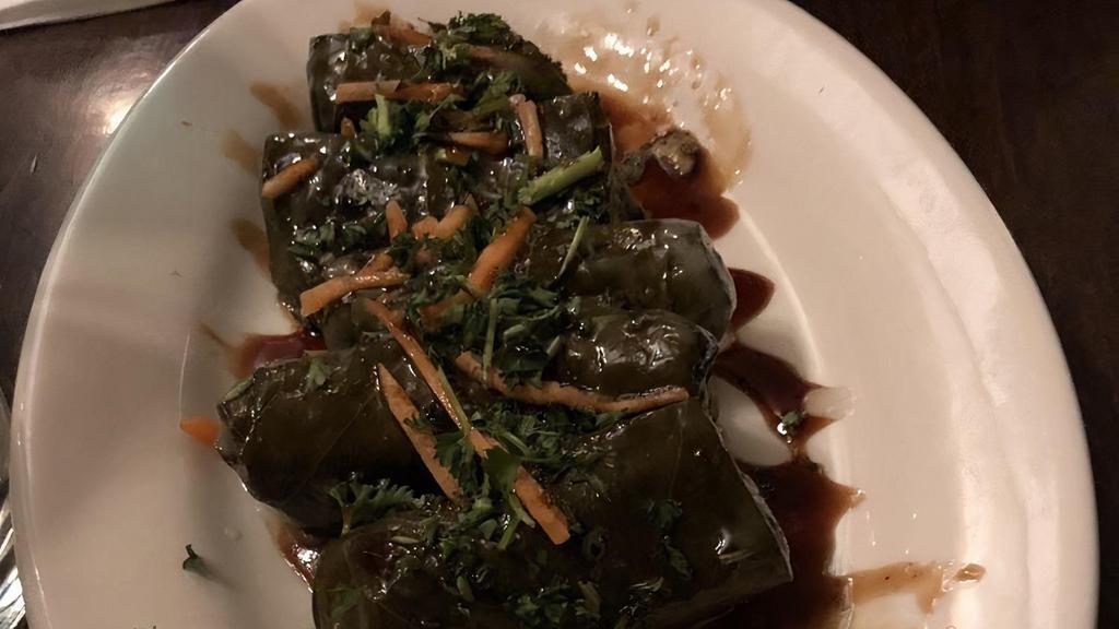 Dolma – Grape Leaves · Tenderized grape leaves rolled with savory vegetable and rice mix with lemon and pomegranate molasses.