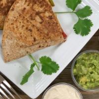 Vegan Quesadilla · Wheat tortilla, vegan cheese blend, caramelized onion peppers, pico de gallo, guacamole, veg...