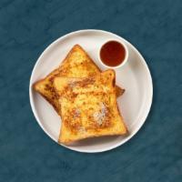 Buttermilk French Toast · Fresh bread battered in egg, milk, and cinnamon cooked until spongy and golden brown. Topped...