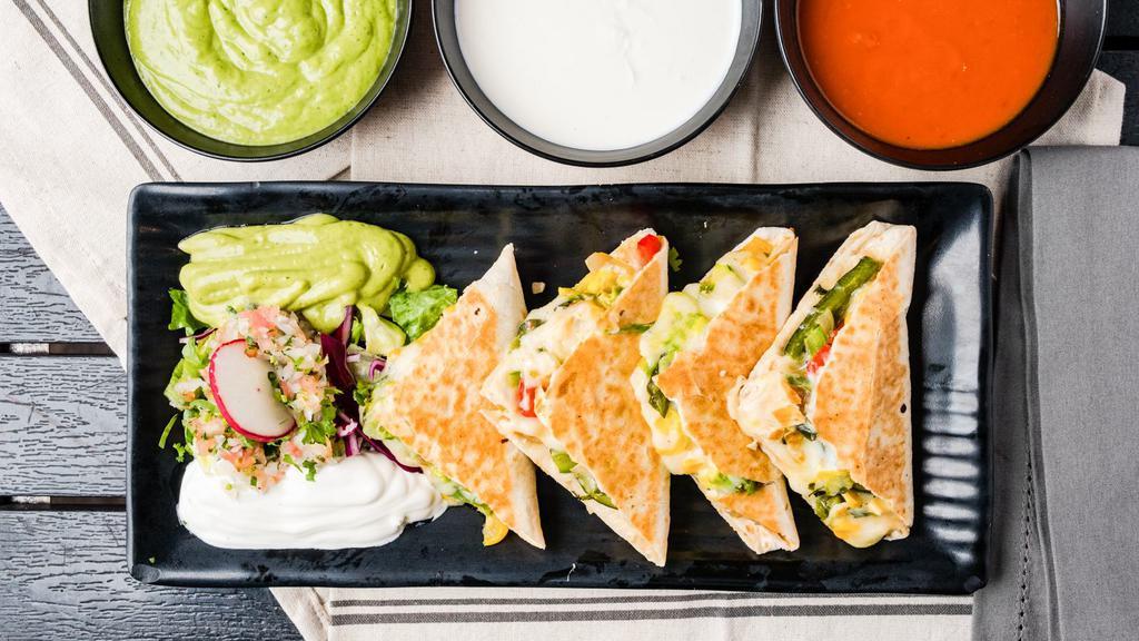 Chicken Tinga Quesadilla · Shredded chicken chipotle. Served in a flour or whole wheat tortilla with melted Mozzarella cheese and pico de gallo. Includes sour cream and guacamole on the side.