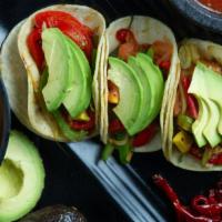 Veggie Avocado Taco · Roasted green and red peppers, tomatoes & avocado. Vegetarian.