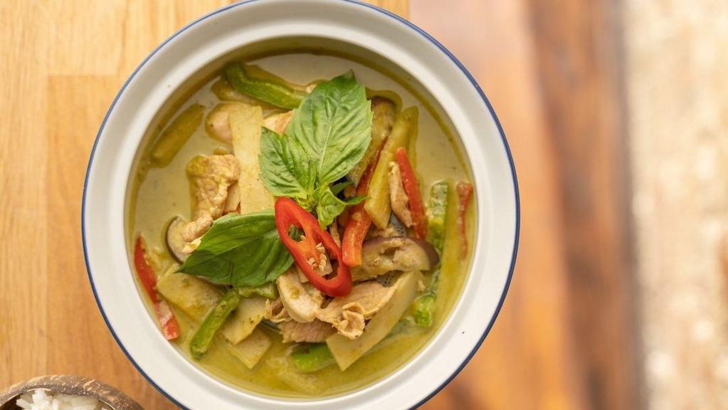 Green Curry · Gluten free. 
Eggplant bamboo shoots, bell peppers, basil, and coconut milk. Served with jasmine rice.